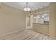 Bright dining room area with modern light fixture, complemented by views of the kitchen at 20 E Serene Ave # 401, Las Vegas, NV 89123