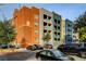 Multi-colored building at 20 E Serene featuring trees, parking spaces, and a blue sky at 20 E Serene Ave # 401, Las Vegas, NV 89123