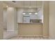 Bright, white kitchen with breakfast bar featuring granite countertops and pendant lighting at 20 E Serene Ave # 401, Las Vegas, NV 89123