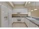 Well-equipped kitchen with white cabinetry, granite countertops, and modern appliances for culinary enthusiasts at 20 E Serene Ave # 401, Las Vegas, NV 89123