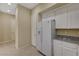Well-lit kitchen with white cabinets, granite countertops, and modern appliances at 20 E Serene Ave # 401, Las Vegas, NV 89123