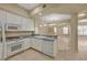 Well-lit kitchen with white cabinetry, granite countertops, and modern appliances at 20 E Serene Ave # 401, Las Vegas, NV 89123