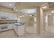 White kitchen offering stainless appliances, granite countertops, and an inviting breakfast bar at 20 E Serene Ave # 401, Las Vegas, NV 89123