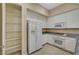 Kitchen showcasing modern white appliances, granite countertops, and extra pantry space at 20 E Serene Ave # 401, Las Vegas, NV 89123