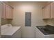 Bright laundry room with upper cabinets and modern washer and dryer at 20 E Serene Ave # 401, Las Vegas, NV 89123