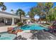 Stunning backyard with a luxurious pool, tanning deck, and outdoor dining area; perfect for entertaining at 2268 Buckingham Ct, Henderson, NV 89074