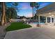 Lush backyard with a manicured lawn, elegant seating, and a covered patio area at 2268 Buckingham Ct, Henderson, NV 89074