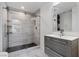Modern bathroom features walk-in shower with glass doors and gray vanity at 2268 Buckingham Ct, Henderson, NV 89074