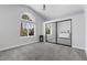 Light-filled bedroom features an arched window and spacious closet with mirrored doors at 2268 Buckingham Ct, Henderson, NV 89074