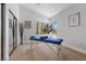 Bright bedroom with wood floors, a massage table, decor art, and a sunny window with exterior views at 2268 Buckingham Ct, Henderson, NV 89074