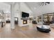 Spacious living room showcases a modern fireplace, wood floors, and views of the backyard at 2268 Buckingham Ct, Henderson, NV 89074