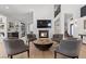 Spacious living room with fireplace, hardwood floors and staircase to upper level at 2268 Buckingham Ct, Henderson, NV 89074