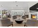 Open living space with modern fireplace, hardwood floors, wet bar, and a view of the pool at 2268 Buckingham Ct, Henderson, NV 89074