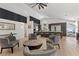 Open-concept living room featuring modern fireplace, hardwood floors, bar and kitchen access at 2268 Buckingham Ct, Henderson, NV 89074