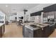Spacious living room with a fireplace and a kitchen with a large center island at 2268 Buckingham Ct, Henderson, NV 89074
