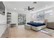Bright primary bedroom features light hardwood floors, recessed lighting, and sliding glass doors to the backyard at 2268 Buckingham Ct, Henderson, NV 89074