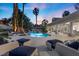 Inviting backyard features a pool, spa, rock waterfall, and plenty of comfortable lounge seating at 2268 Buckingham Ct, Henderson, NV 89074