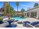 Resort-style pool features a rock waterfall, a built in spa, and comfortable seating areas at 2268 Buckingham Ct, Henderson, NV 89074