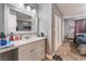 Bathroom vanity area with a large framed mirror, drawers, and a view to the bedroom at 25 Colbath St, Las Vegas, NV 89110