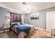 Neutral bedroom featuring a modern ceiling fan, tiled floors, and natural light at 25 Colbath St, Las Vegas, NV 89110