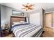 Bedroom featuring a wooden-framed bed, a ceiling fan, and mirrored closet doors at 25 Colbath St, Las Vegas, NV 89110