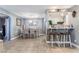 Cozy dining area next to the kitchen, featuring tile floors and a modern chandelier at 25 Colbath St, Las Vegas, NV 89110