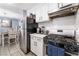 Efficient kitchen with stainless steel appliances, white cabinets, and view to the dining area at 25 Colbath St, Las Vegas, NV 89110