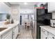 Updated kitchen view with modern sink and breakfast bar, flowing into a dining area at 25 Colbath St, Las Vegas, NV 89110