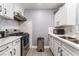 Clean kitchen with white cabinets, stainless steel appliances, and updated countertops at 25 Colbath St, Las Vegas, NV 89110