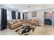 Cozy living room featuring neutral colors, comfortable seating, and tiled floors at 25 Colbath St, Las Vegas, NV 89110