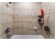 Tiled shower featuring unique, decorative accent tiles and a hand-held shower head at 25 Colbath St, Las Vegas, NV 89110