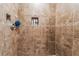 Tiled shower with a built-in niche for storage and decorative mosaic accent tiling at 25 Colbath St, Las Vegas, NV 89110