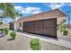 Tan low-rise building with brown metal fence and desert landscaping of gravel and shrubs at 2635 Heritage Ct, Las Vegas, NV 89121