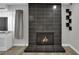Modern tiled fireplace with an adjacent window creates a focal point in the living area, blending style with warmth at 2635 Heritage Ct, Las Vegas, NV 89121