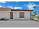 Tan single-story home with simple landscaping and a concrete driveway under a partly cloudy sky at 2635 Heritage Ct, Las Vegas, NV 89121