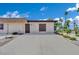 Tan single-story home with simple landscaping and a concrete driveway under a partly cloudy sky at 2635 Heritage Ct, Las Vegas, NV 89121