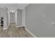 Hallway with wood-look flooring, neutral paint, and access to various rooms at 2635 Heritage Ct, Las Vegas, NV 89121