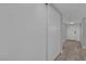 Hallway with closet doors and front door with glass window inset at the end at 2635 Heritage Ct, Las Vegas, NV 89121