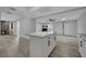 Open-concept kitchen features a central island, blending functionality with modern living, adjacent to a fireplace at 2635 Heritage Ct, Las Vegas, NV 89121