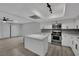 Well-lit kitchen features an island, stainless steel appliances, and a modern design with gray backsplash at 2635 Heritage Ct, Las Vegas, NV 89121
