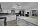 Bright, renovated kitchen with white cabinets, stainless steel appliances, and gray backsplash tile at 2635 Heritage Ct, Las Vegas, NV 89121