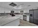 Well-lit kitchen featuring white cabinetry, stainless steel appliances, and quartz countertops at 2635 Heritage Ct, Las Vegas, NV 89121