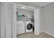 Clean and organized laundry room with washer, dryer, and ample shelving for storage, perfect for household tasks at 2635 Heritage Ct, Las Vegas, NV 89121