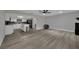 Open-concept living space showcasing wood-look floors, a modern kitchen, and a cozy living room area at 2635 Heritage Ct, Las Vegas, NV 89121
