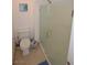 Bathroom featuring a toilet and a glass door shower, complemented by neutral-toned walls and flooring at 270 E Flamingo Rd # 223, Las Vegas, NV 89169