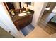 Bathroom featuring a vanity with granite countertop and wood cabinets, complemented by neutral-toned walls and flooring at 270 E Flamingo Rd # 223, Las Vegas, NV 89169