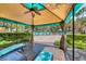 Relaxing cabana with cushioned seating, a ceiling fan, and views of the lush pool area at 270 E Flamingo Rd # 223, Las Vegas, NV 89169