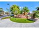 Community signage with manicured lawns, flowers, palm trees, and blue skies at 270 E Flamingo Rd # 223, Las Vegas, NV 89169