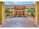 Exterior view of building featuring landscaped courtyard, water feature and vibrant architecture at 270 E Flamingo Rd # 223, Las Vegas, NV 89169