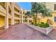 Well-maintained exterior courtyard showcasing garden beds, mature trees, and architectural design at 270 E Flamingo Rd # 223, Las Vegas, NV 89169